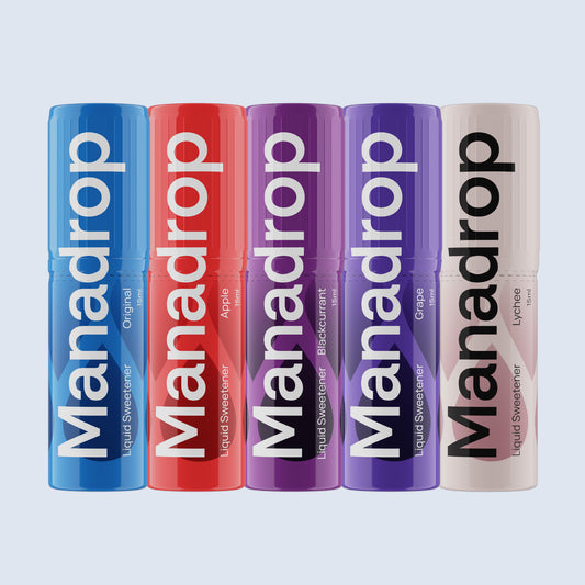 Five Manadrop liquid sweetener bottles in different colors on a light gray background